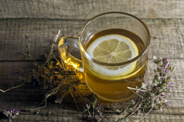 Lemon balm leaves next to a steaming cup